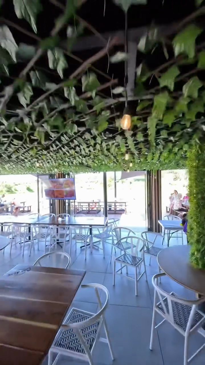 Inside the thatched restaurant, open to the dam